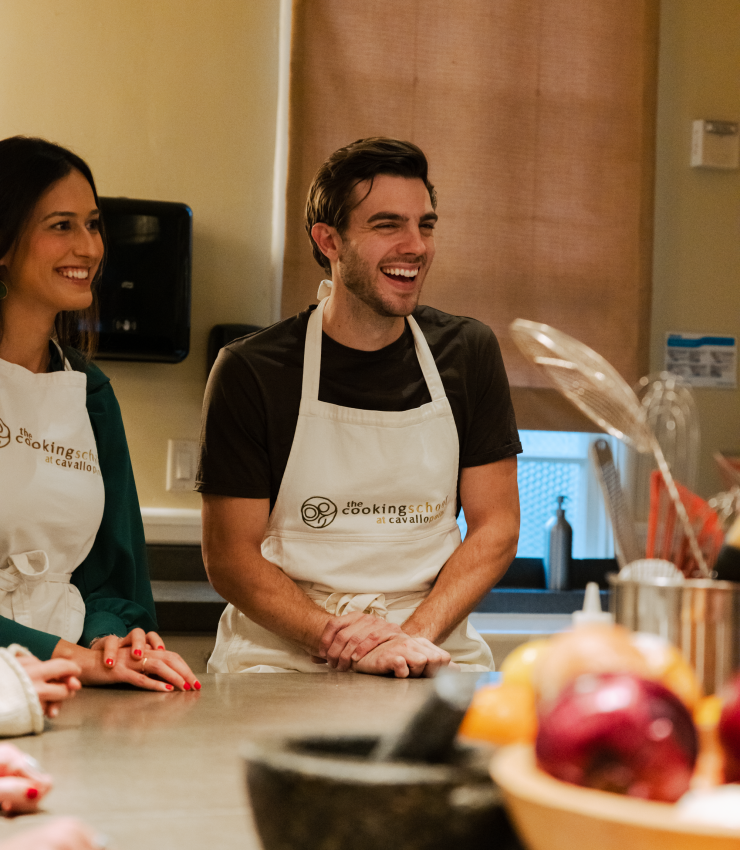 Group of two smiling cooking school