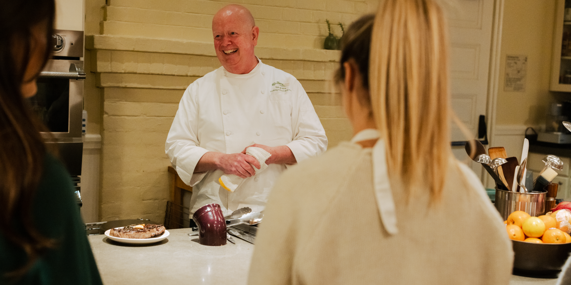 Chef smiling with group cooking school