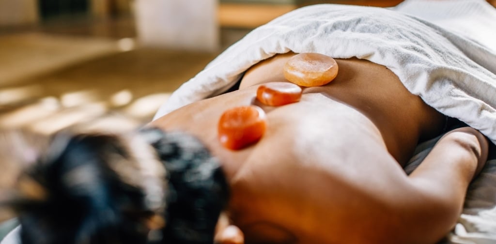 spa woman with rocks on back