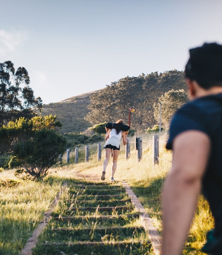 woman and man hiking up stairs