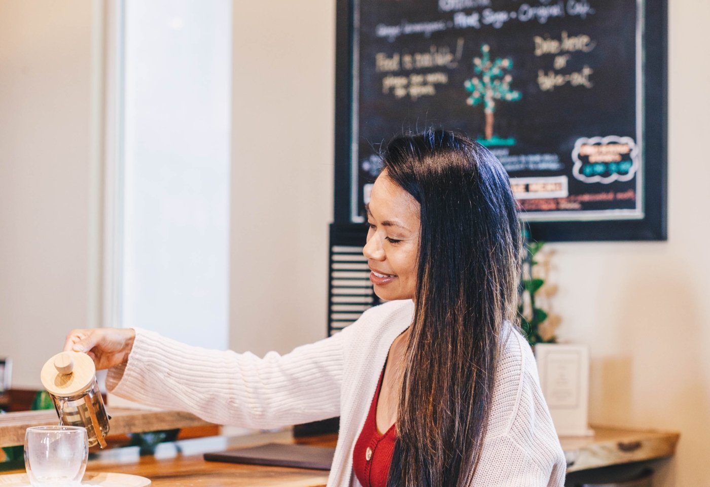 Woman pouring tea at tea bar