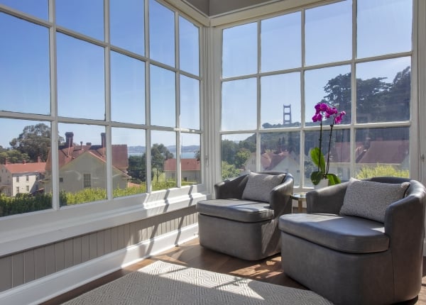 indoor seating area with two chairs and windows overlooking the Golden Gate Bridge