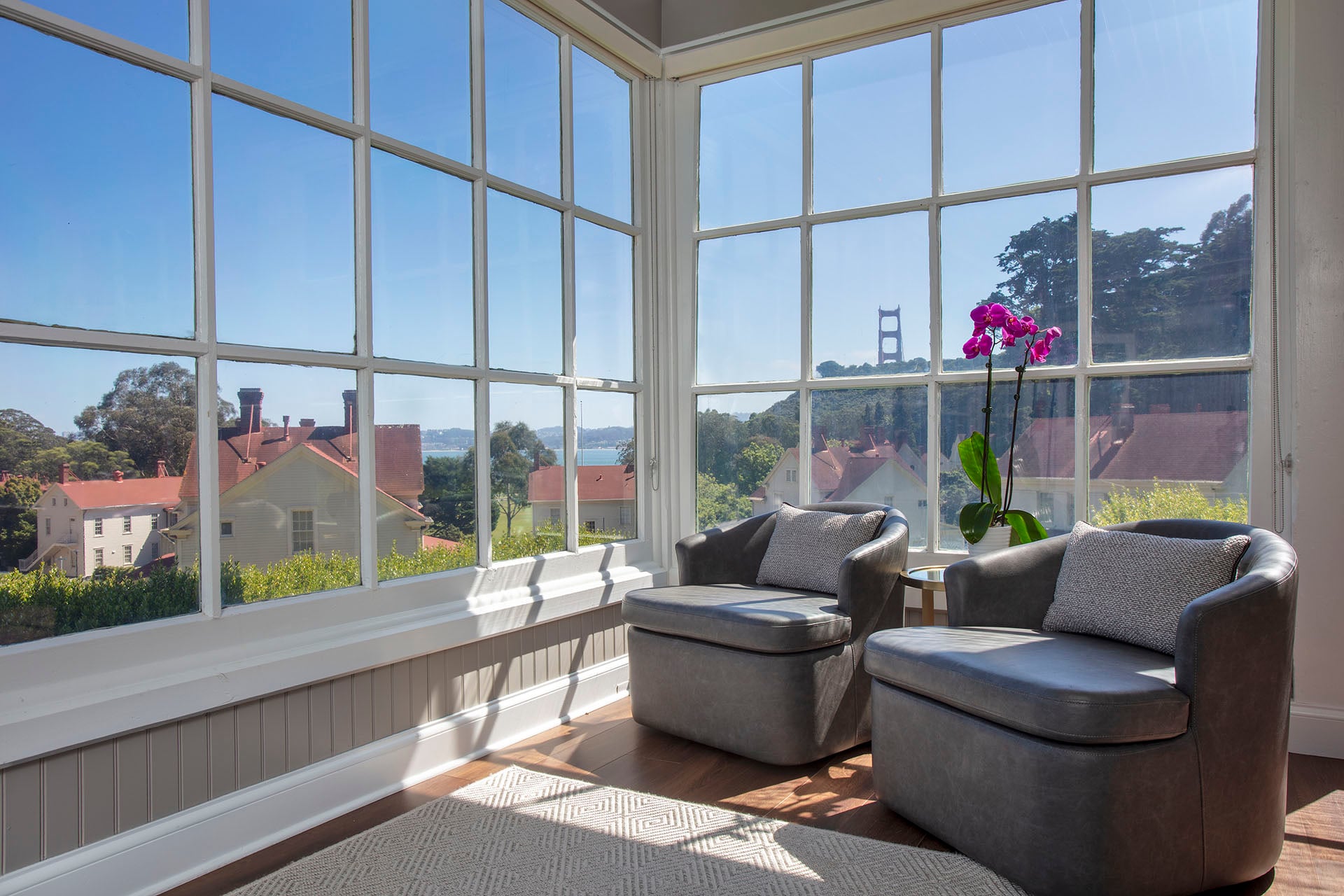 indoor seating area with two chairs and windows overlooking the Golden Gate Bridge