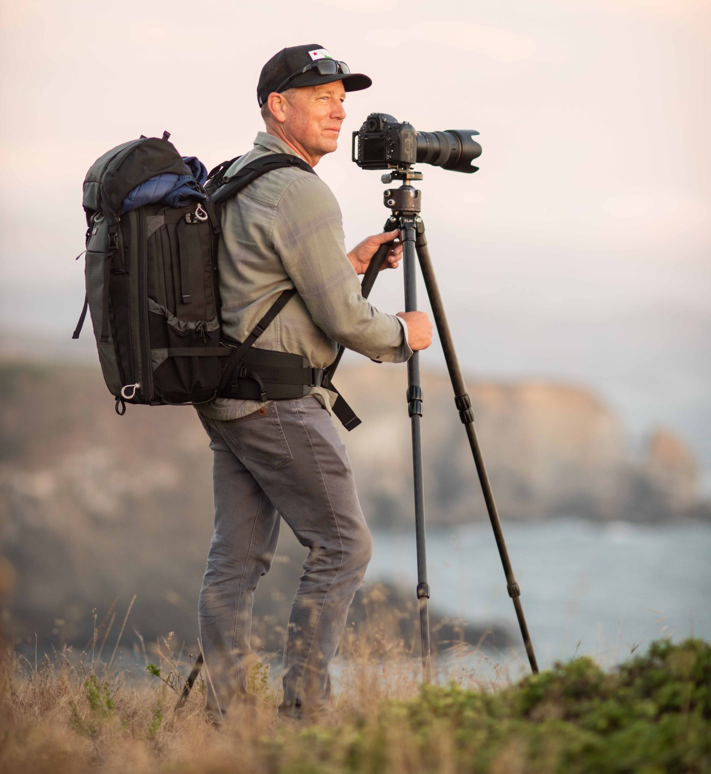 photographer standing with camera outdoors