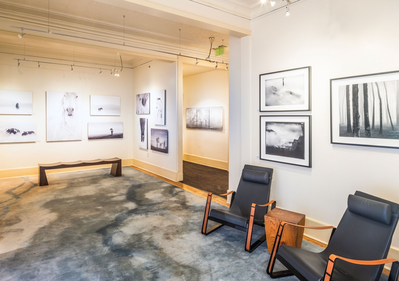 cavallo point art gallery with photos on the wall and two chairs