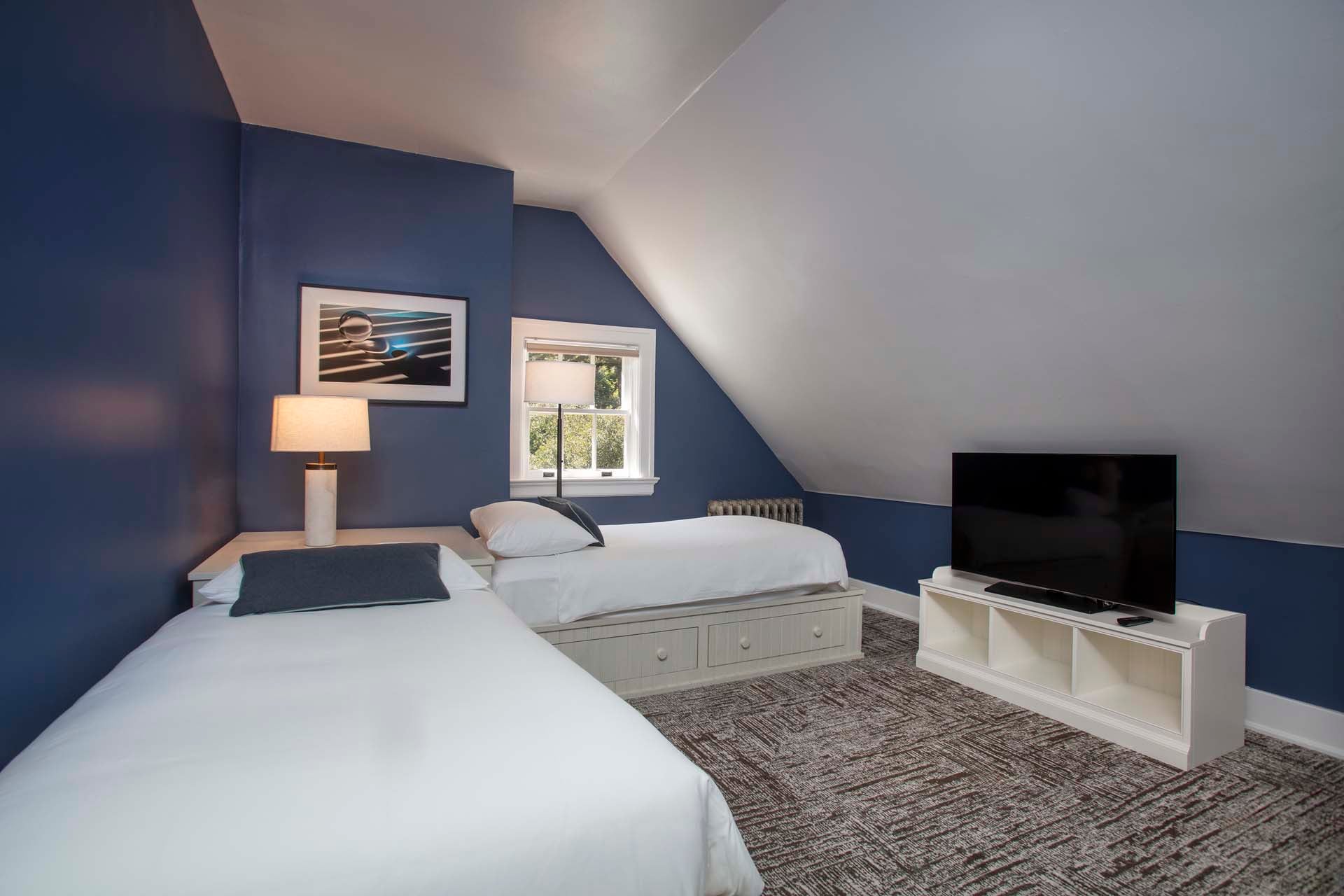Bedroom with two twin beds and TV