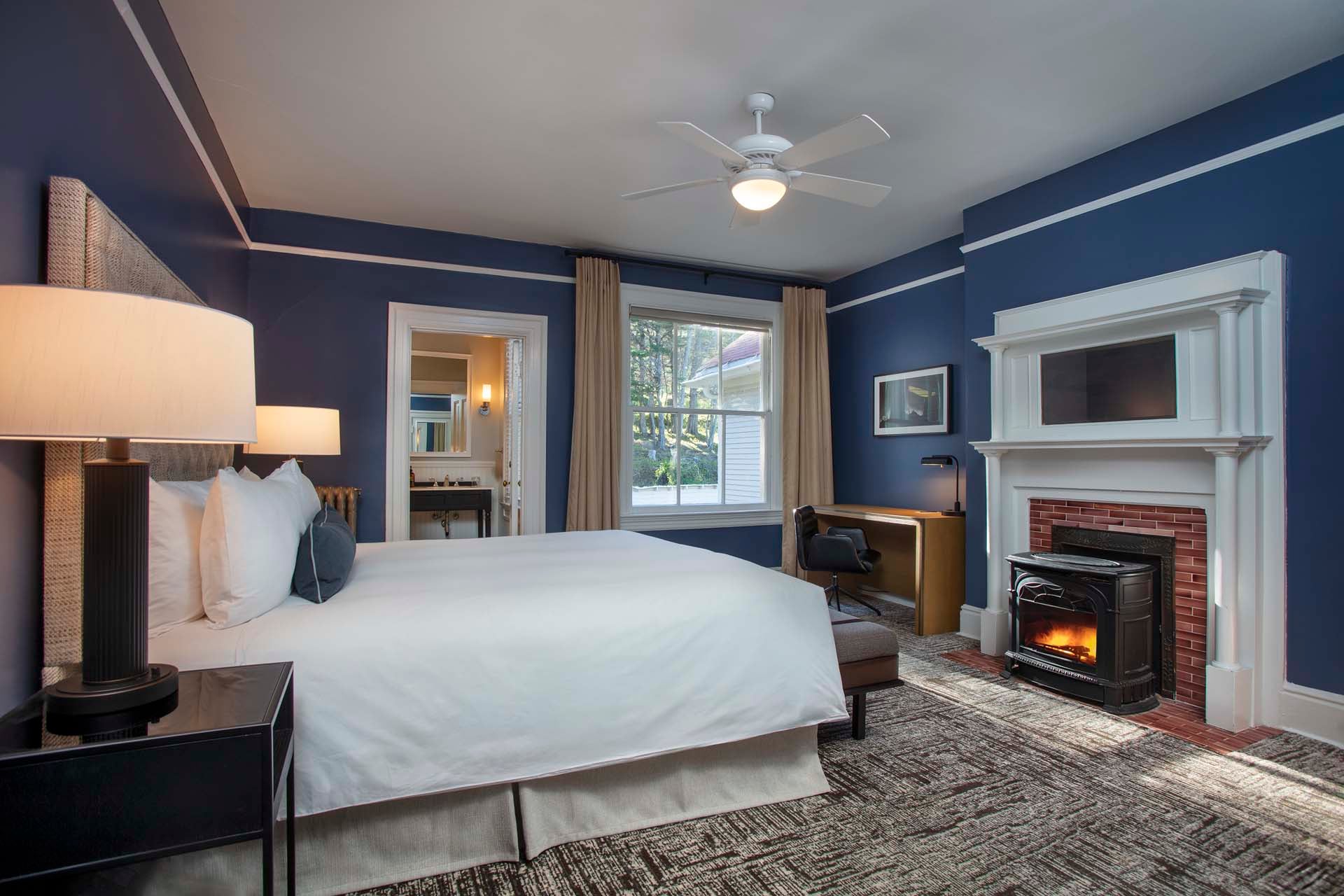 Historic bedroom with desk, fireplace and King bed