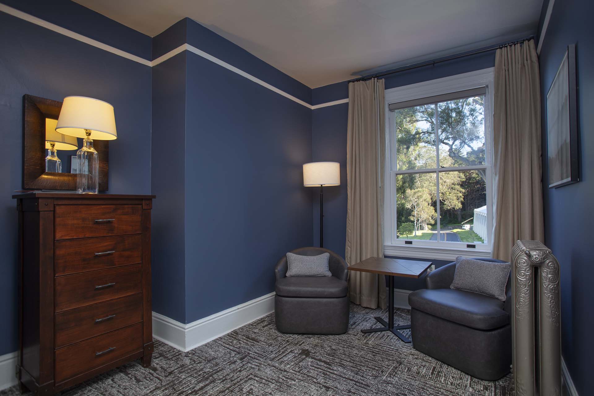 Sitting area with two chairs, a table, vanity and view of the grounds
