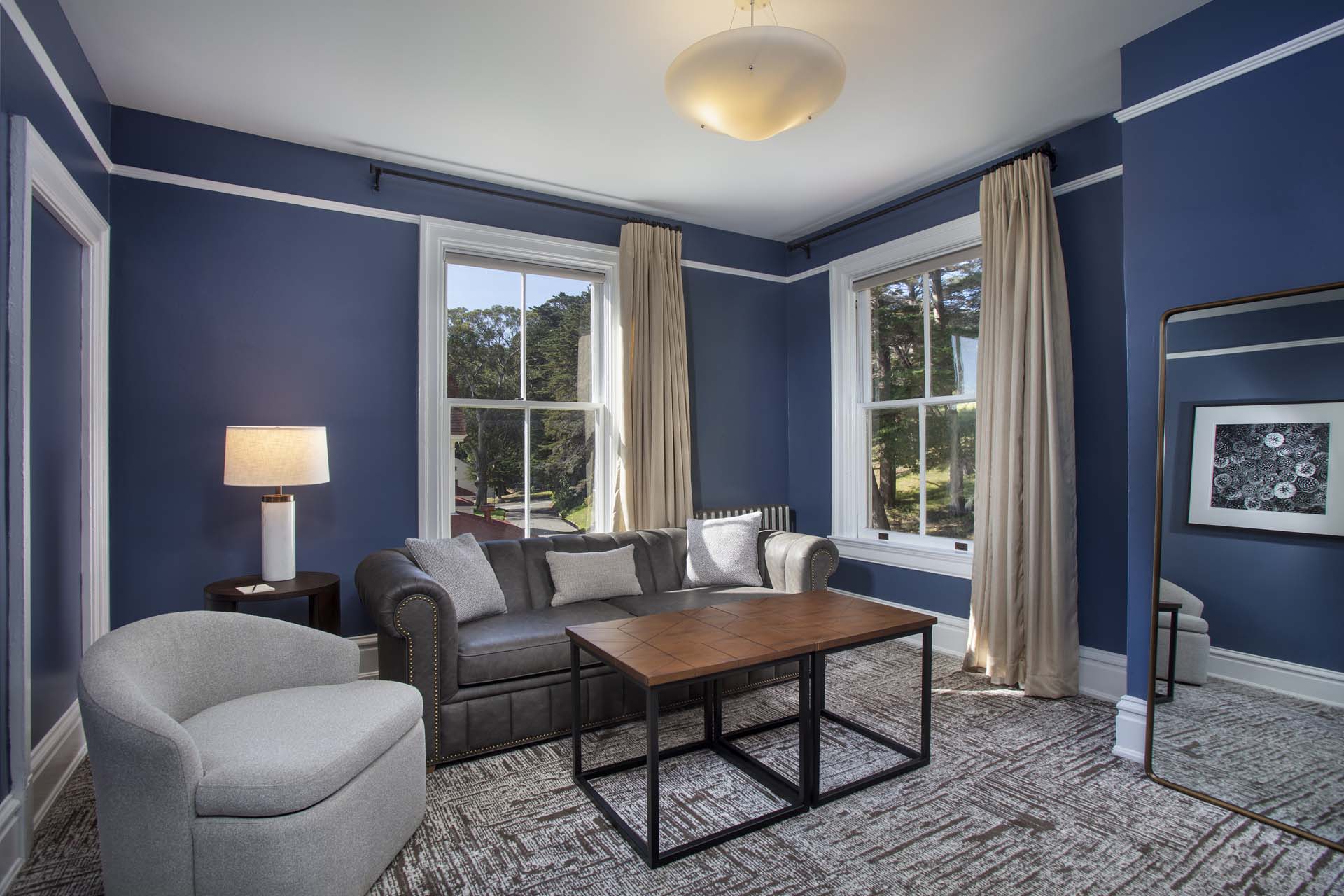 Historic sitting room with chair, couch, table and mirror