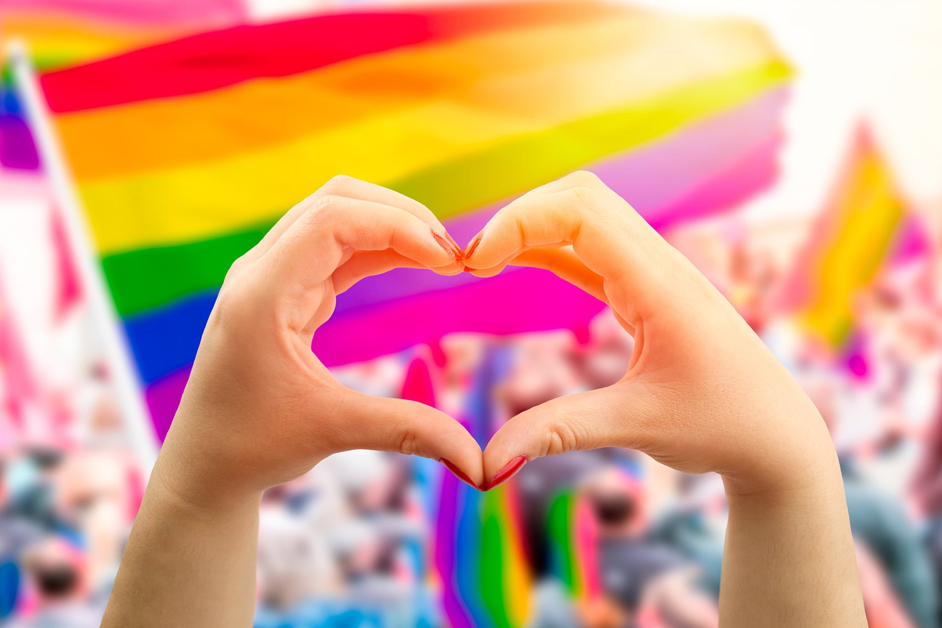pride flag and two hands making a heart