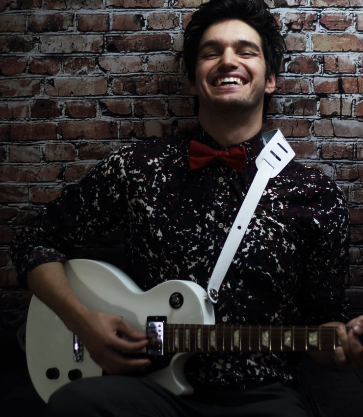 john vicino holding a guitar
